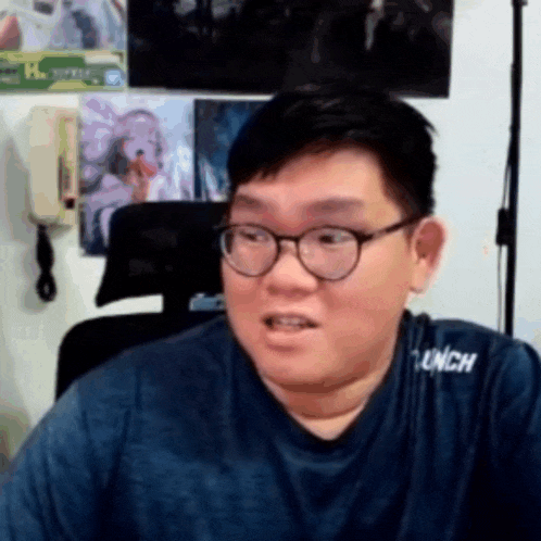 a man wearing glasses and a shirt that says launch on it