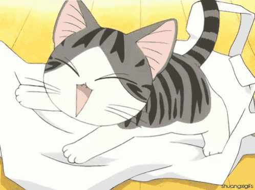 a gray and white cat is laying on a white blanket with its mouth open
