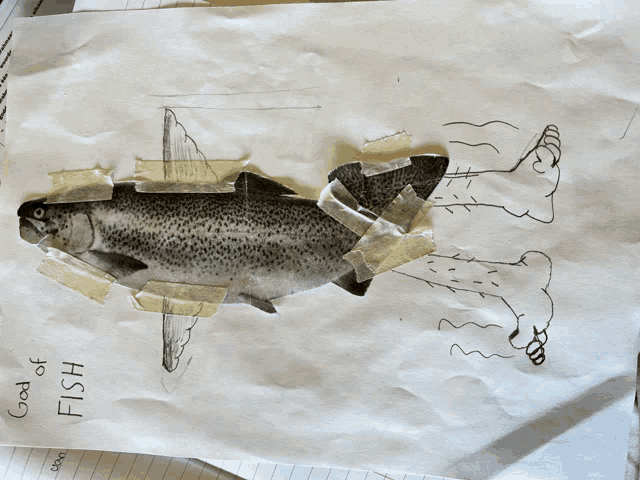 a drawing of a fish is taped to a piece of paper that says fish