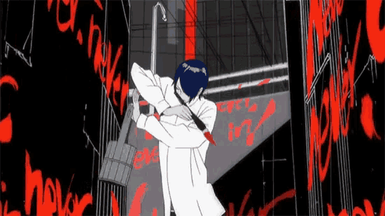 a man in a white coat is standing in front of a wall with red graffiti .
