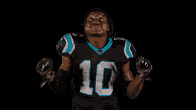 a man in a panthers jersey with the number 10 on it