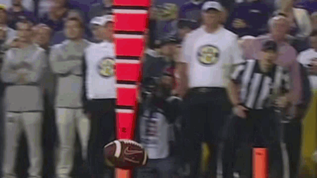 a football is being thrown in the air by a referee