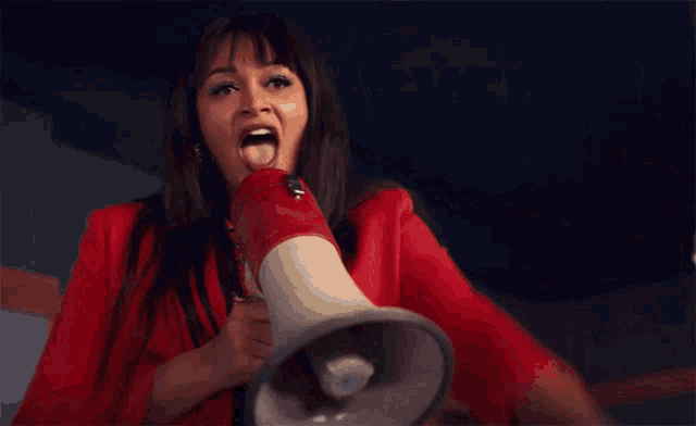 a woman is holding a megaphone and pointing to the word one