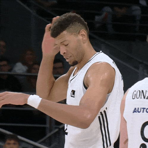 a basketball player named gonz is standing next to another player