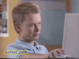 a man sitting in front of a computer with a gif me app logo on the bottom
