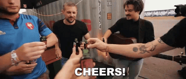 a group of men are toasting with bottles of beer and the word cheers is being displayed