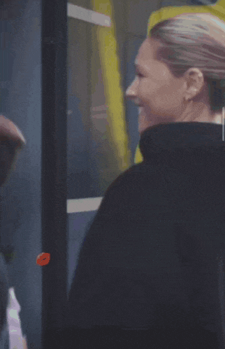 a woman wearing a black hoodie with a kiss on it
