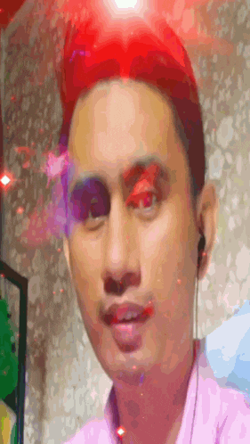 a man with red hair is wearing earphones and a pink shirt .