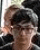 a close up of a person wearing glasses and a hat .