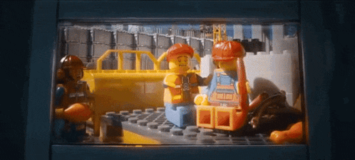 a group of lego workers are working on a construction project