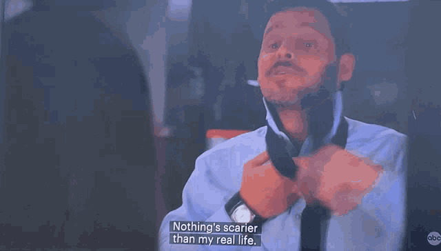 a man in a white shirt and tie is saying nothing 's scarier than my real life