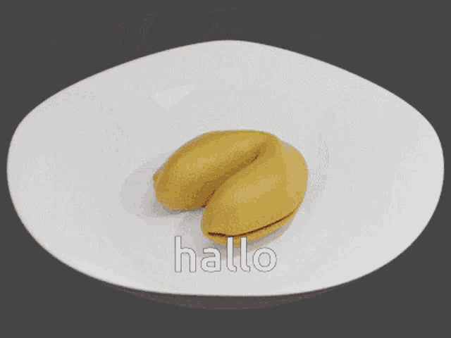 a yellow fortune cookie with a picture of a cartoon character and the word hallo on the bottom