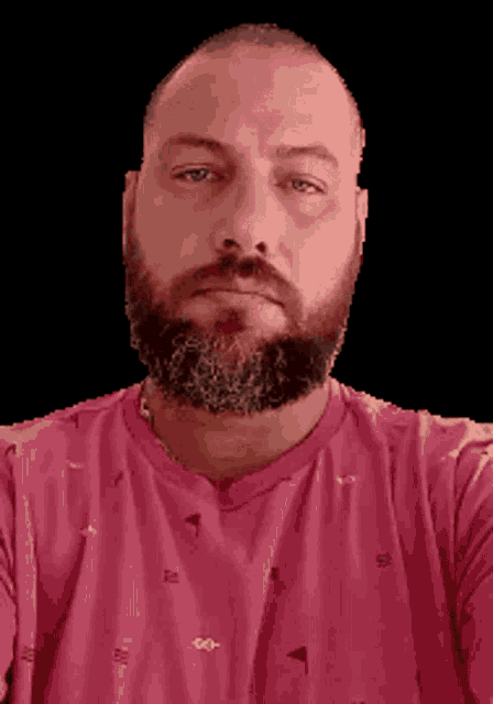 a man with a beard is wearing a pink shirt with a golf pattern