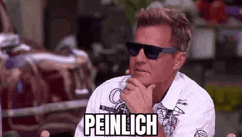 a man wearing sunglasses and a white shirt is sitting down with his hand on his chin and the word peinlich on his face .
