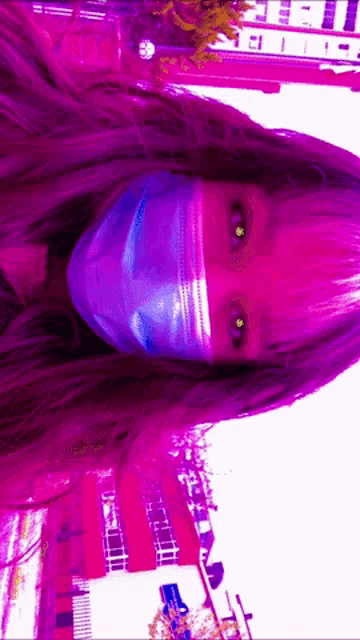 a woman wearing a blue face mask with purple eyes