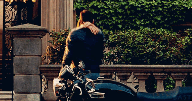 a man and woman are kissing while riding a motorcycle with the word cast on the bottom