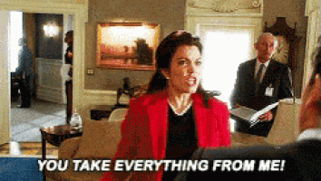a woman in a red jacket is talking to a man in a suit and says you take everything from me