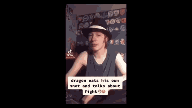 a young man wearing a hat and a tank top is talking about a dragon eating his own snot .