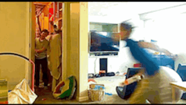 a blurry picture of people in a living room and a closet