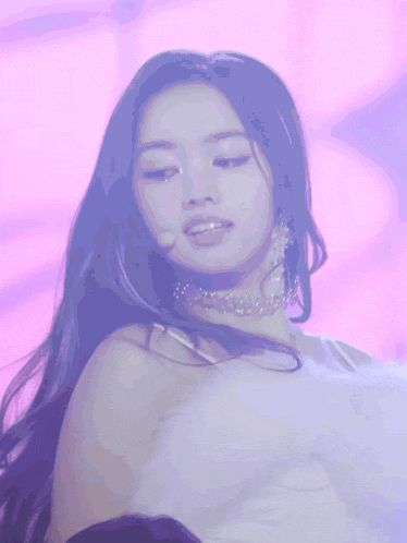 a close up of a woman wearing a choker on a stage