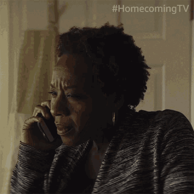 a woman is talking on a cell phone with #homecoming tv written on the bottom
