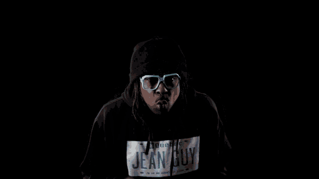 a man wearing glasses and a hoodie that says jean guy on it