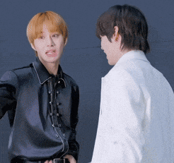 two men are standing next to each other and one is wearing a white shirt
