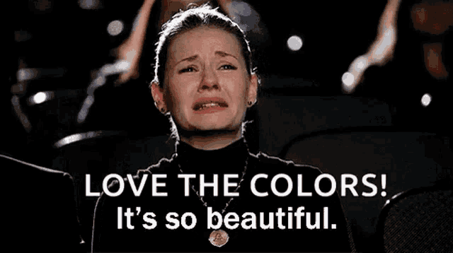 a woman is crying while watching a movie and the words love the colors it 's so beautiful
