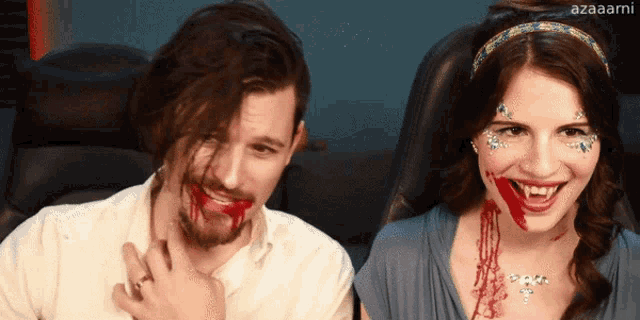 a man and a woman with blood on their faces are sitting next to each other
