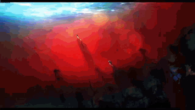 a computer screen displays a painting of a red and blue sky