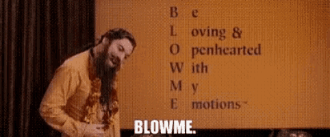 a man with a beard is blowing a kiss in front of a sign that says be loving and openhearted with my emotions