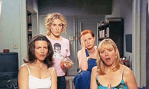 a group of women standing next to each other in a room .