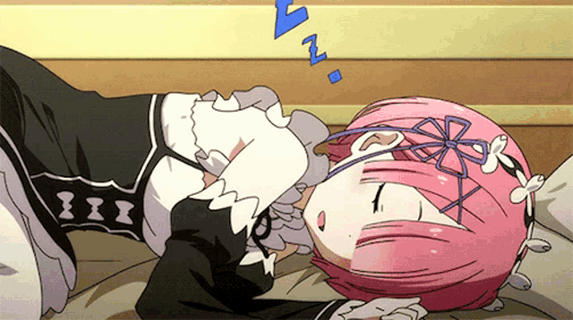 a girl with pink hair is sleeping on a bed with the letters a and z above her head