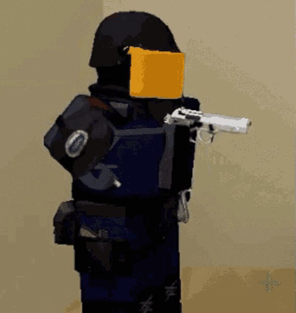 a robot is holding a gun and wearing a helmet and shield .