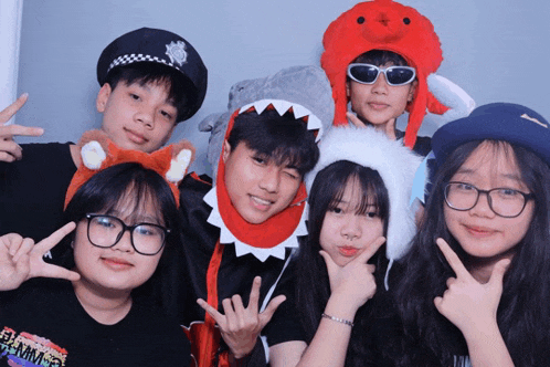 a group of young people posing for a picture with one girl wearing a shirt that says ' summer ' on it