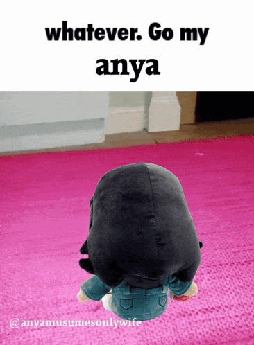 a stuffed animal is sitting on a pink rug with the words whatever go my anya above it