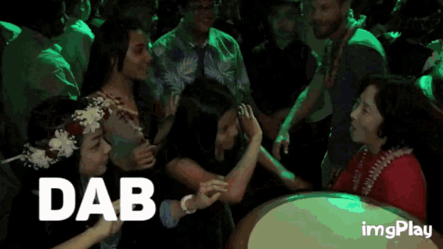 a group of people are dancing in a dark room and the word dab is visible