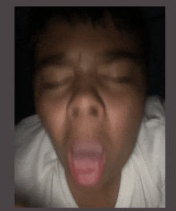 a close up of a person 's face with their mouth open