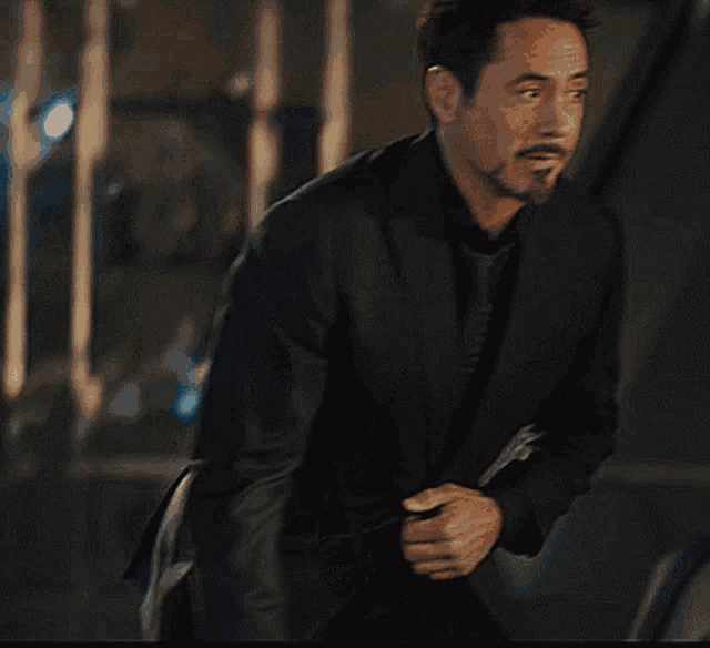 a man with a beard and mustache is wearing a suit