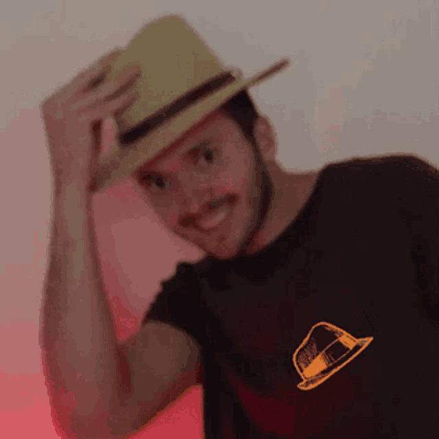 a man wearing a straw hat and a black shirt