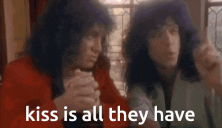 two people laying next to each other and the words kiss is all they have