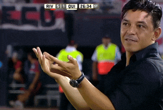 a man applauds in front of a scoreboard that says river 511 on it