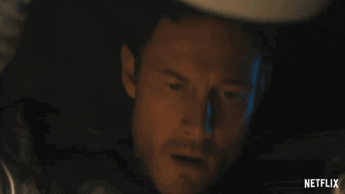 a close up of a man 's face with a netflix logo in the background