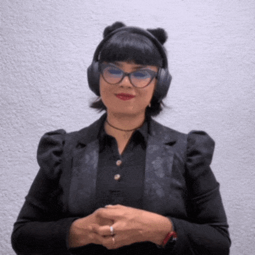 a woman wearing a cat ear headband and headphones