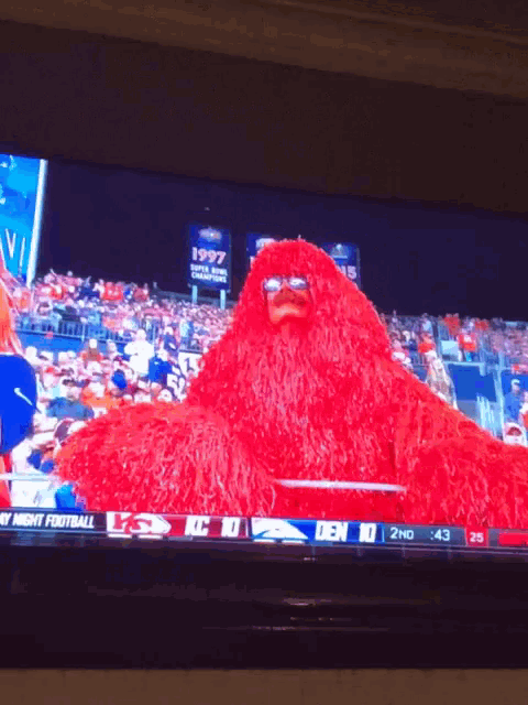a football game is being shown on a television screen