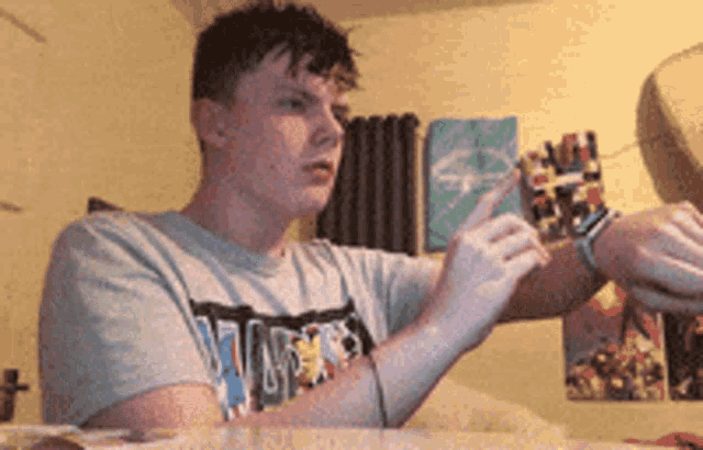 a man wearing a vans t-shirt is pointing at something
