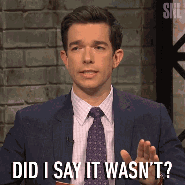a man in a suit and tie is saying did i say it wasn 't