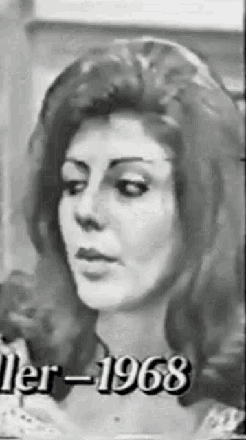 a black and white photo of a woman 's face with the year 1968 written on the bottom .