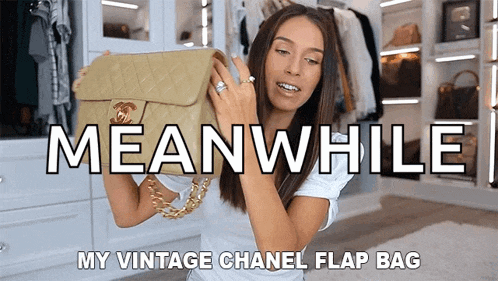 a woman holding a vintage chanel flap bag in a closet