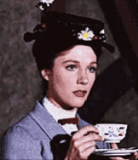 a woman wearing a hat with daisies on it is drinking from a cup